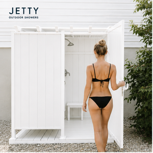 white vinyl outdoor shower enclosure by jetty homes featuring a clean costal design, privacy walls, and durable weather resistant construction
